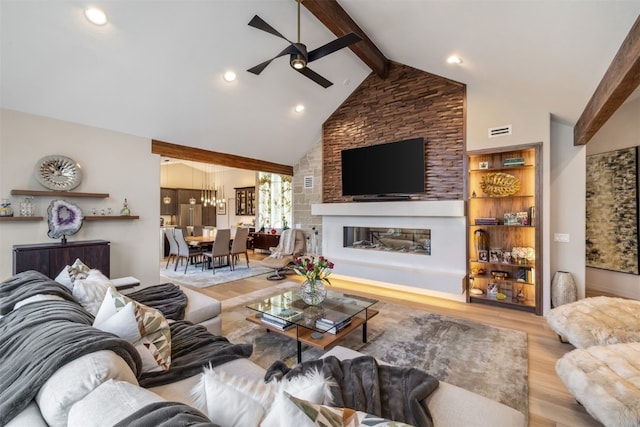 456 Forest Hills Dr, Breckenridge, CO 80424 - living room featuring a ceiling fan, wood finished floors, beamed ceiling, a chandelier, and a large fireplace