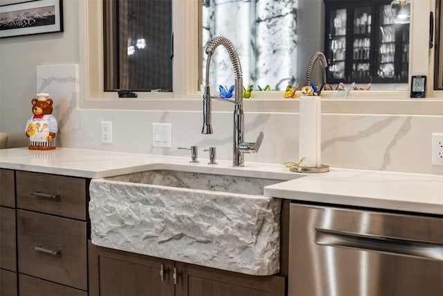 456 Forest Hills Dr, Breckenridge, CO 80424 - detailed view of dishwasher, dark brown cabinetry, and light stone counters