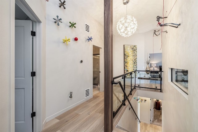 456 Forest Hills Dr, Breckenridge, CO 80424 - corridor with an upstairs landing, light wood-style floors, and a chandelier