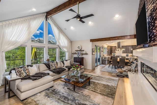 456 Forest Hills Dr, Breckenridge, CO 80424 - living area with high vaulted ceiling, a ceiling fan, beam ceiling, light wood finished floors, and a chandelier