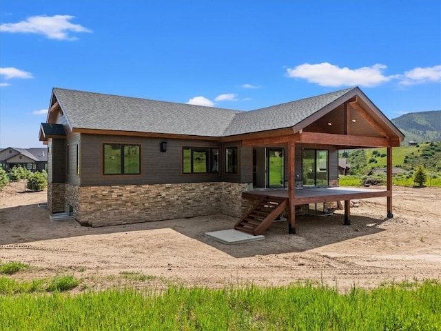 30350 Hostler Dr, Oak Creek, CO 80467 - back of property with a shingled roof, stone siding, and a mountain view