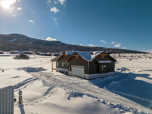 30350 Hostler Dr, Oak Creek, CO 80467 - view of front of house featuring a garage and a mountain view