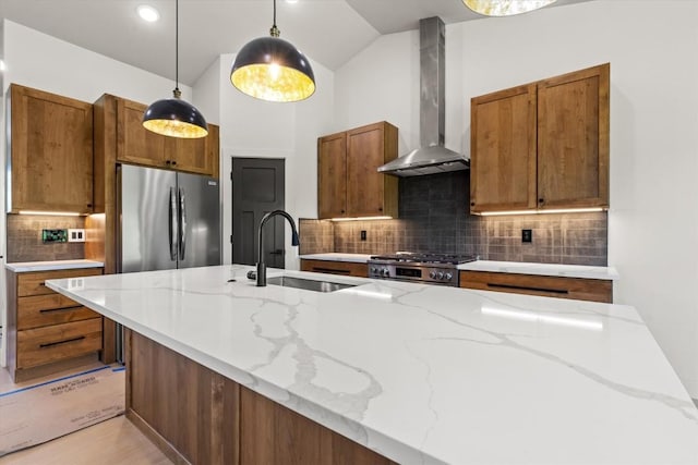 30350 Hostler Dr, Oak Creek, CO 80467 - kitchen with wall chimney exhaust hood, appliances with stainless steel finishes, tasteful backsplash, brown cabinetry, and lofted ceiling