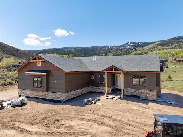 30350 Hostler Dr, Oak Creek, CO 80467 - view of front of property with stone siding, a mountain view, and a shingled roof