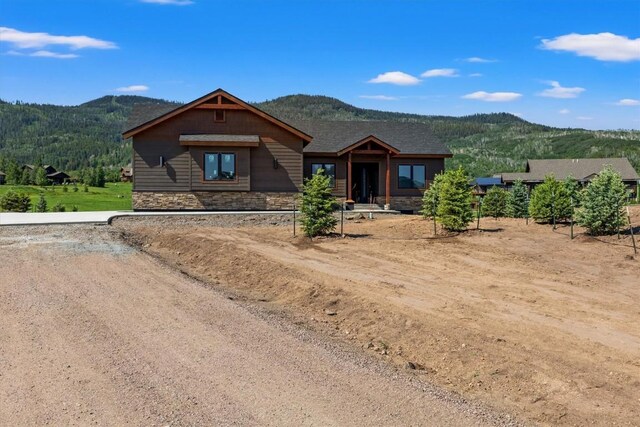 30350 Hostler Dr, Oak Creek, CO 80467 - view of front of house with a mountain view and stone siding