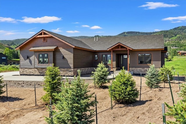30350 Hostler Dr, Oak Creek, CO 80467 - view of front facade featuring stone siding and a mountain view