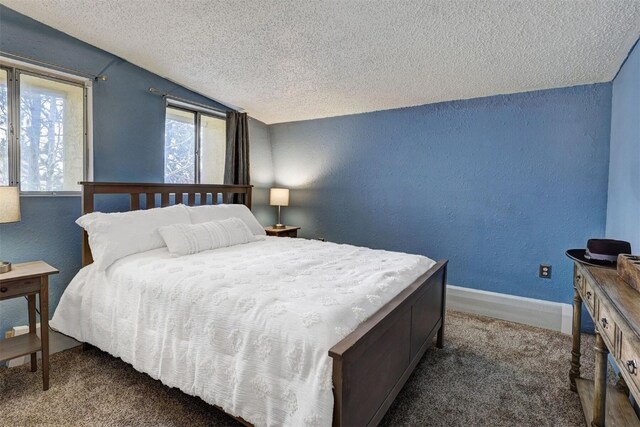 carpeted bedroom featuring lofted ceiling and a textured ceiling