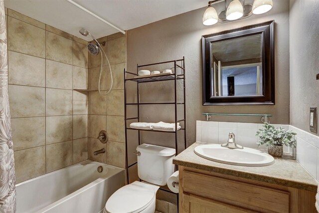 full bathroom with backsplash, vanity, shower / bath combo, and toilet