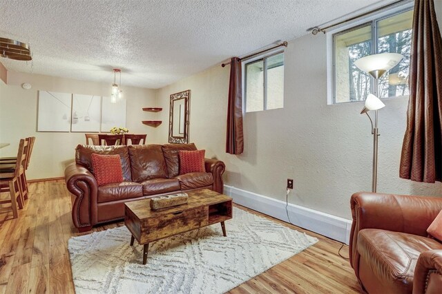 living room featuring a textured ceiling and light wood-type flooring