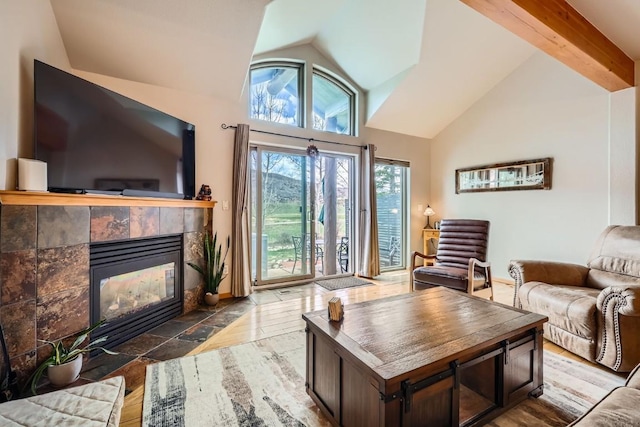 320 Kestrel Ln Unit 320, Silverthorne, CO 80498 - living area featuring a fireplace, high vaulted ceiling, and stone tile floors