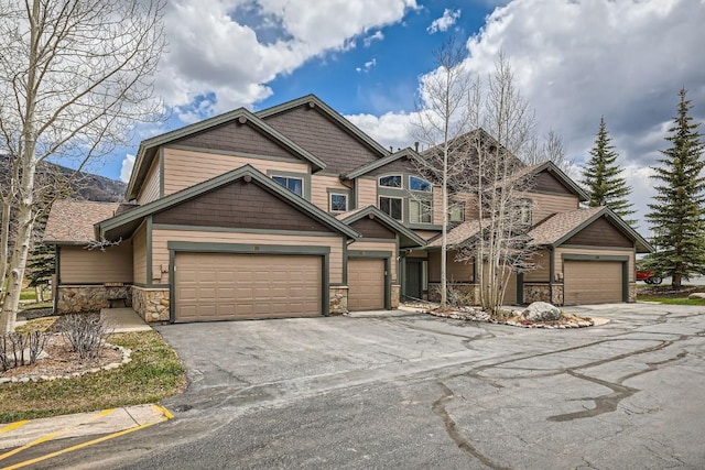 320 Kestrel Ln Unit 320, Silverthorne, CO 80498 - craftsman-style house with stone siding, driveway, and a garage