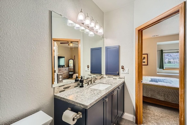 320 Kestrel Ln Unit 320, Silverthorne, CO 80498 - bathroom featuring ensuite bathroom, a textured wall, vanity, ceiling fan, and baseboards