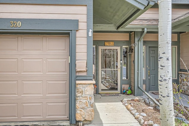 320 Kestrel Ln Unit 320, Silverthorne, CO 80498 - doorway to property featuring a garage and a porch
