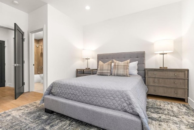 1241 Urban Way, Steamboat Springs, CO 80487 - bedroom featuring wood finished floors, recessed lighting, ensuite bath, and baseboards