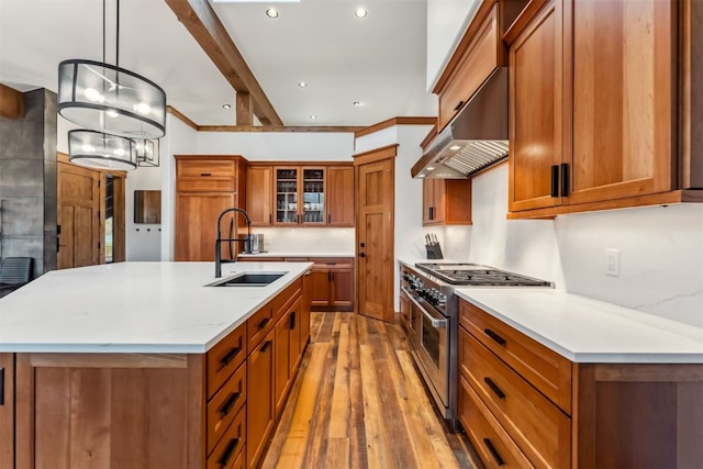 128 Union Trl, Breckenridge, CO 80424 - kitchen with double oven range, brown cabinetry, extractor fan, light wood finished floors, and recessed lighting