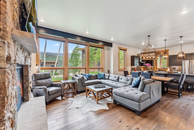 7 Moss Way, Silverthorne, CO 80498 - living room with a chandelier, light wood-type flooring, a fireplace, and recessed lighting