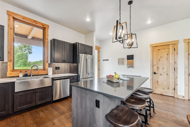 7 Moss Way, Silverthorne, CO 80498 - kitchen featuring stainless steel appliances, dark wood-style flooring, decorative backsplash, a breakfast bar, and recessed lighting