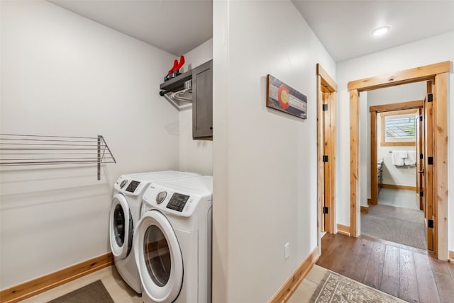 7 Moss Way, Silverthorne, CO 80498 - washroom with independent washer and dryer, cabinet space, and light wood-style flooring
