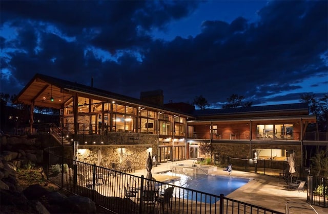 7 Moss Way, Silverthorne, CO 80498 - back of house at twilight with a balcony and a patio area