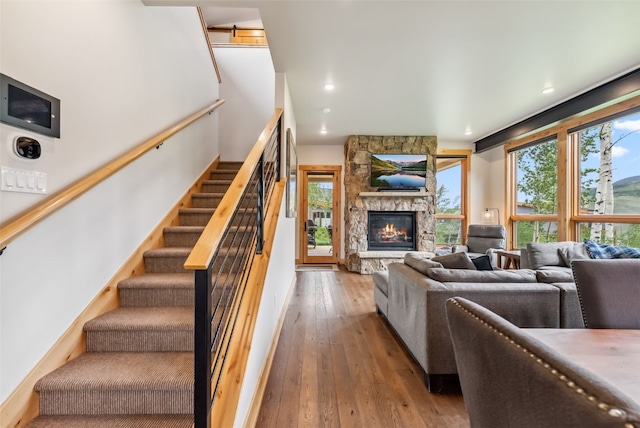 7 Moss Way, Silverthorne, CO 80498 - living room with healthy amount of natural light, a fireplace, hardwood / wood-style floors, stairs, and recessed lighting