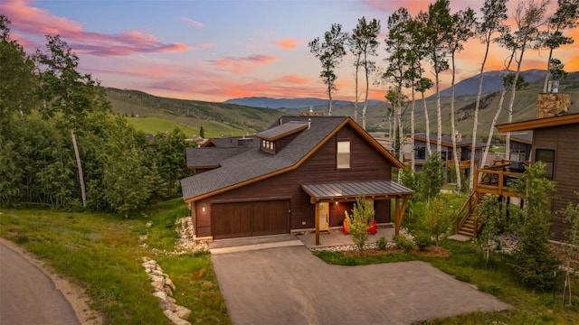 7 Moss Way, Silverthorne, CO 80498 - view of front facade featuring driveway, roof with shingles, a mountain view, covered porch, and a standing seam roof
