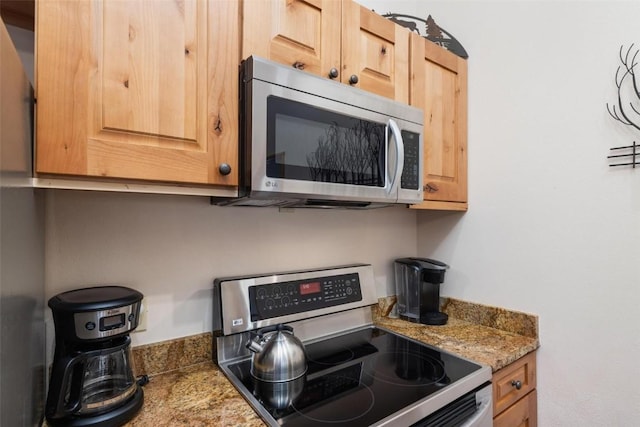 kitchen featuring light brown cabinetry and stainless steel appliances