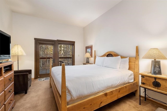 bedroom featuring light colored carpet and vaulted ceiling
