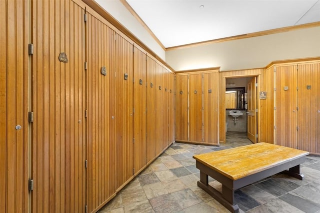 hall featuring stone finish floor and ornamental molding