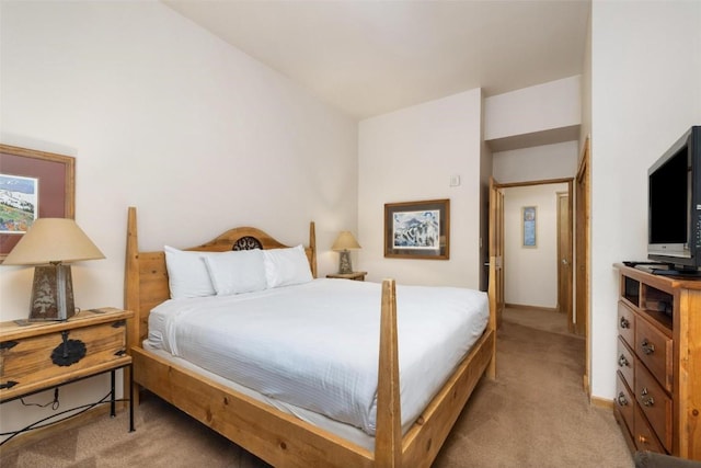 bedroom featuring light colored carpet