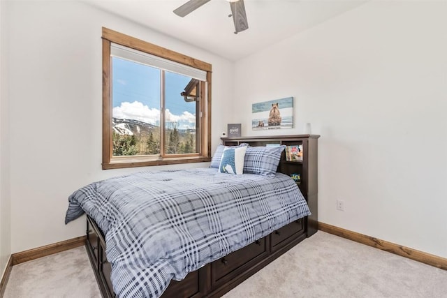 carpeted bedroom with baseboards and a ceiling fan