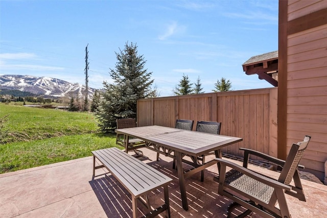 view of patio / terrace featuring a mountain view and outdoor dining space