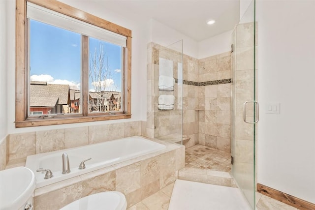 full bath featuring a garden tub, a stall shower, and toilet