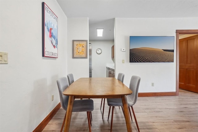 22787 US Highway 6 Unit 302, Keystone, CO 80435 - dining room with light wood-style flooring and baseboards