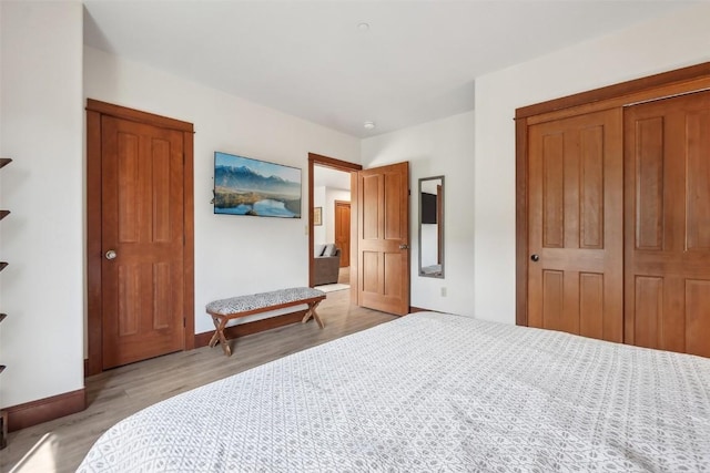 22787 US Highway 6 Unit 302, Keystone, CO 80435 - bedroom with light wood-style floors, a closet, and baseboards