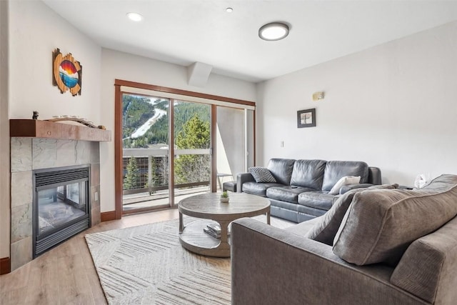22787 US Highway 6 Unit 302, Keystone, CO 80435 - living area featuring a tiled fireplace and light wood-style flooring