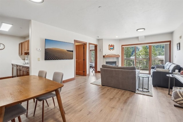 22787 US Highway 6 Unit 302, Keystone, CO 80435 - living room featuring a fireplace, light wood-style floors, and baseboards