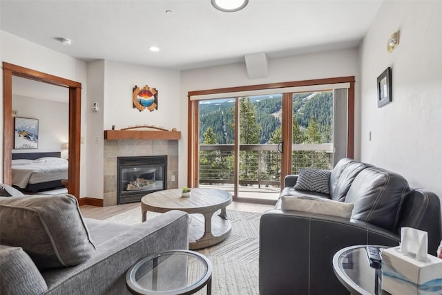 22787 US Highway 6 Unit 302, Keystone, CO 80435 - living room featuring wood finished floors, a tiled fireplace, and recessed lighting