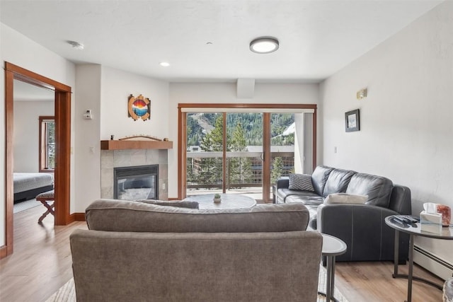 22787 US Highway 6 Unit 302, Keystone, CO 80435 - living area featuring a baseboard heating unit, light wood-style flooring, a fireplace, and recessed lighting