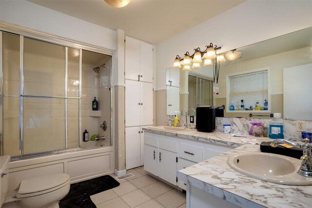 951 Alta Vista Dr, Craig, CO 81625 - full bathroom featuring tile patterned floors, double vanity, combined bath / shower with glass door, and toilet