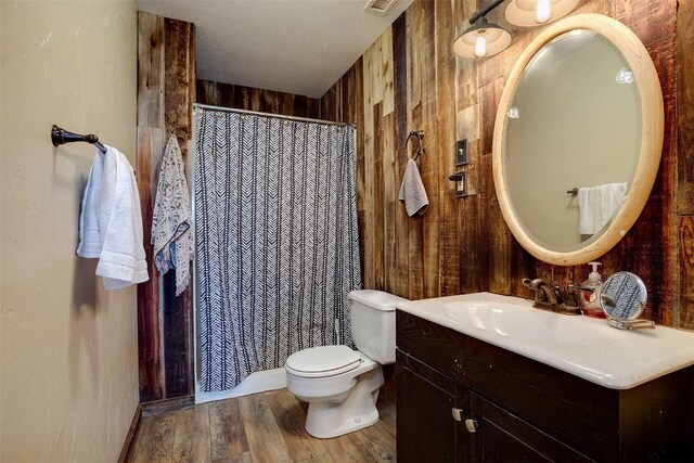 951 Alta Vista Dr, Craig, CO 81625 - full bath featuring vanity, toilet, wood finished floors, a shower with shower curtain, and wood walls