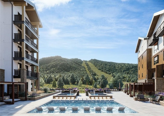 75 Hunki Dori Ct Unit E503, Keystone, CO 80435 - view of pool with a pool with connected hot tub, a forest view, and a mountain view