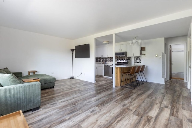 180 Evergreen Rd Unit 105, Dillon, CO 80435 - living area with wood finished floors and a chandelier