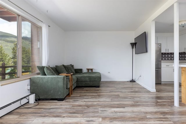 180 Evergreen Rd Unit 105, Dillon, CO 80435 - living room with a baseboard heating unit and light wood-style flooring