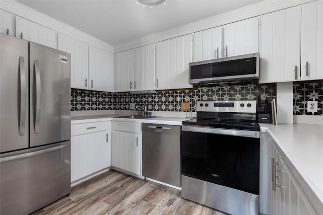 180 Evergreen Rd Unit 105, Dillon, CO 80435 - kitchen with stainless steel appliances, light countertops, backsplash, and white cabinets
