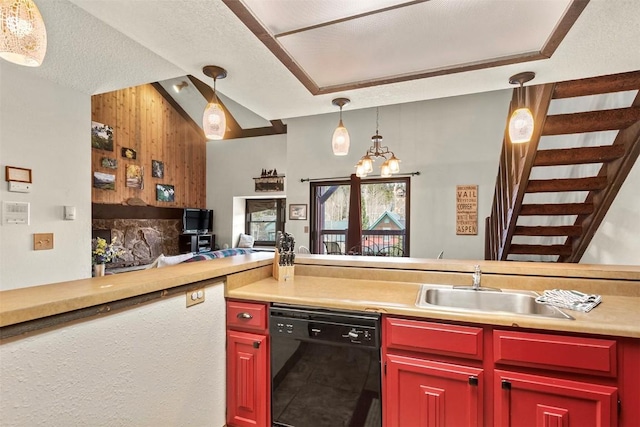 kitchen with a sink, open floor plan, a chandelier, dishwasher, and pendant lighting