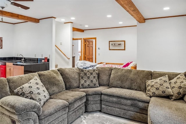living area with crown molding, recessed lighting, a ceiling fan, beamed ceiling, and stairway