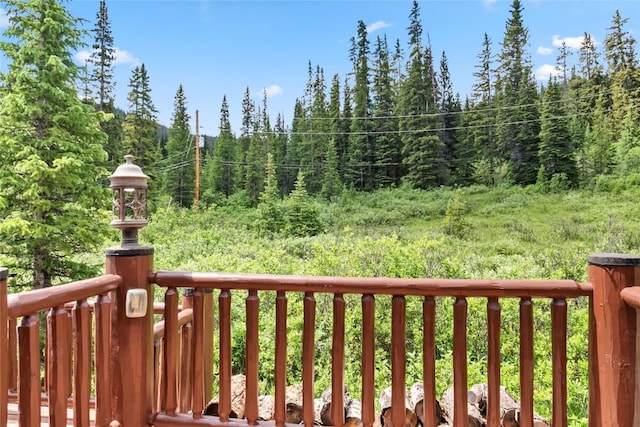 wooden terrace with a wooded view