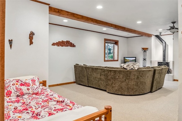 welcome area featuring a wood stove, recessed lighting, and beam ceiling