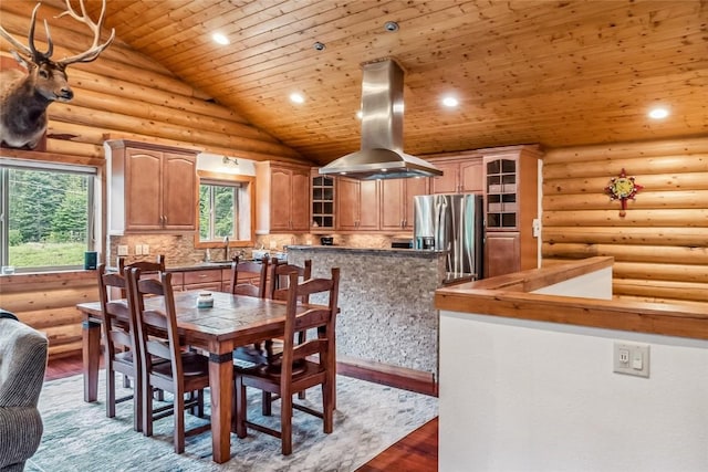 dining room featuring wood finished floors, recessed lighting, wood ceiling, rustic walls, and vaulted ceiling