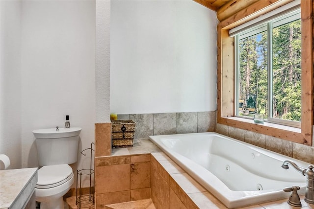 bathroom featuring a tub with jets and toilet
